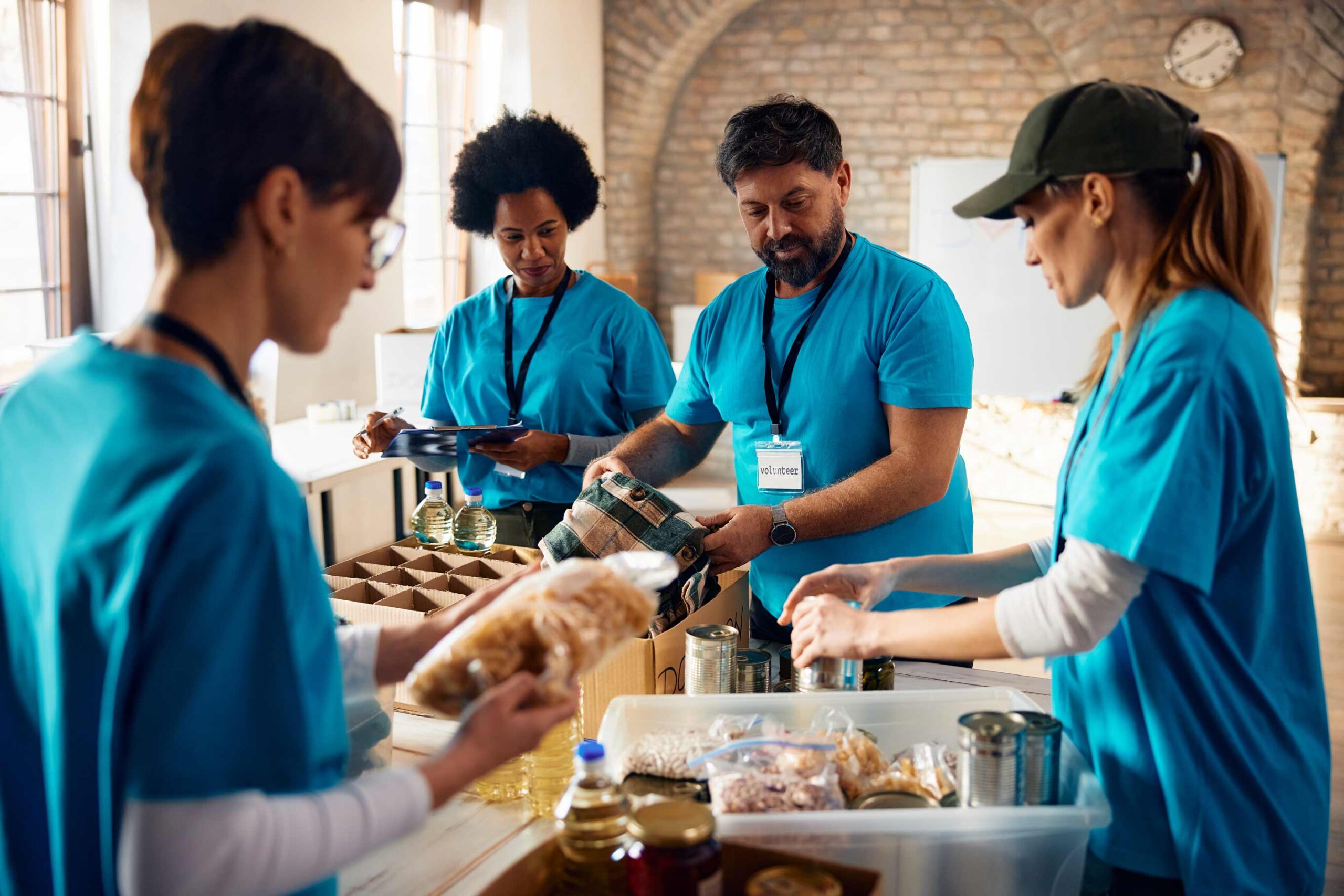 multiracial-group-of-volunteers-packing-groceries-2024-02-09-19-33-52-utc